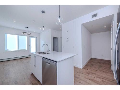 3407-111 Wolf Creek Drive Se, Calgary, AB - Indoor Photo Showing Kitchen With Double Sink With Upgraded Kitchen