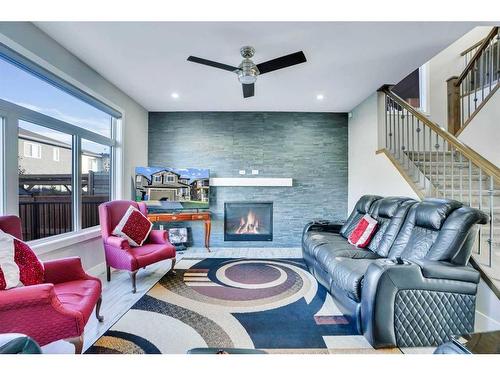 208 Bayview Street Sw, Airdrie, AB - Indoor Photo Showing Living Room With Fireplace