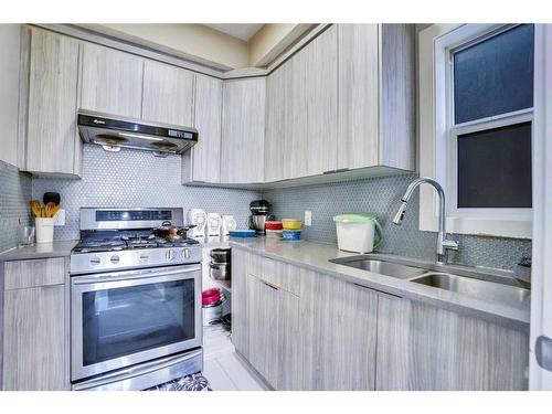 208 Bayview Street Sw, Airdrie, AB - Indoor Photo Showing Kitchen With Double Sink