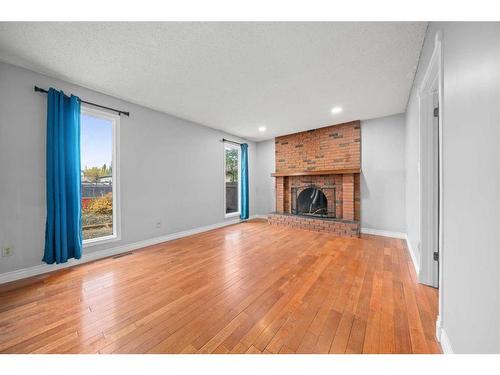 1202 Murdoch Street, Crossfield, AB - Indoor Photo Showing Living Room With Fireplace