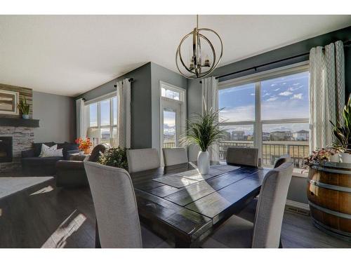 6 Ranchers Bay, Okotoks, AB - Indoor Photo Showing Dining Room With Fireplace