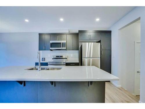 822 Windbury Street Sw, Airdrie, AB - Indoor Photo Showing Kitchen With Stainless Steel Kitchen With Double Sink With Upgraded Kitchen