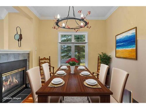 19-164 Rundle Drive, Canmore, AB - Indoor Photo Showing Dining Room With Fireplace