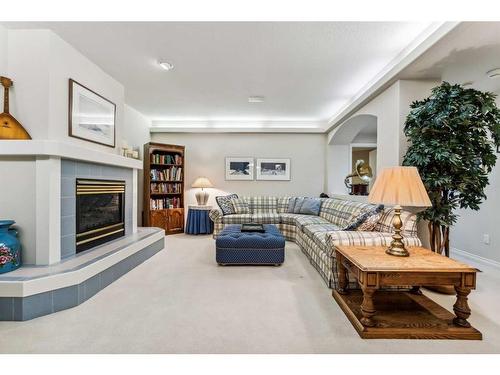 107 Sunrise Way, Priddis Greens, AB - Indoor Photo Showing Living Room With Fireplace