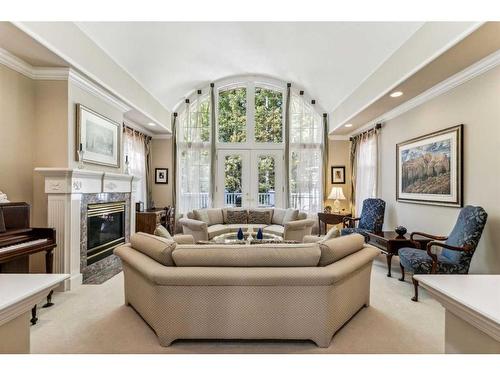 107 Sunrise Way, Priddis Greens, AB - Indoor Photo Showing Living Room With Fireplace