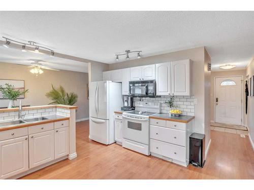 17 Alcock Street, Okotoks, AB - Indoor Photo Showing Kitchen With Double Sink