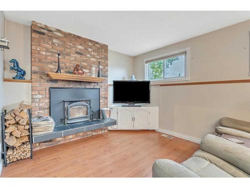 17 Alcock Street, Okotoks, AB - Indoor Photo Showing Living Room With Fireplace