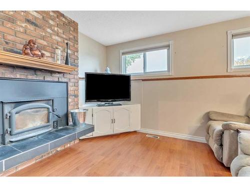 17 Alcock Street, Okotoks, AB - Indoor Photo Showing Living Room With Fireplace