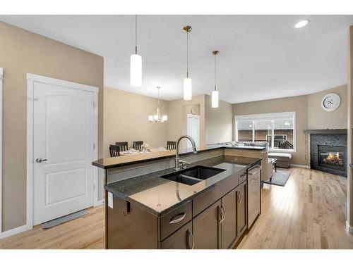 187 Evansridge Circle Nw, Calgary, AB - Indoor Photo Showing Kitchen With Fireplace With Double Sink