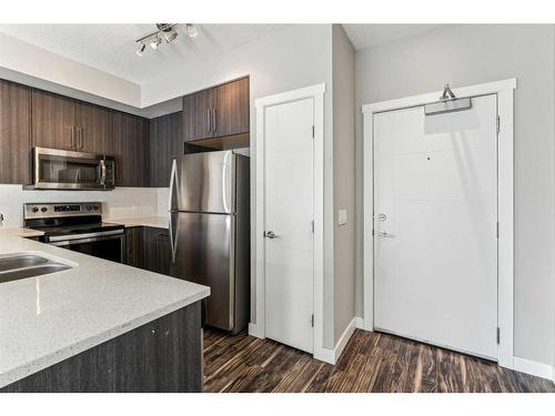 106-605 17 Avenue Nw, Calgary, AB - Indoor Photo Showing Kitchen With Stainless Steel Kitchen With Double Sink