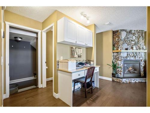 145 Crystal Shores Grove, Okotoks, AB - Indoor With Fireplace