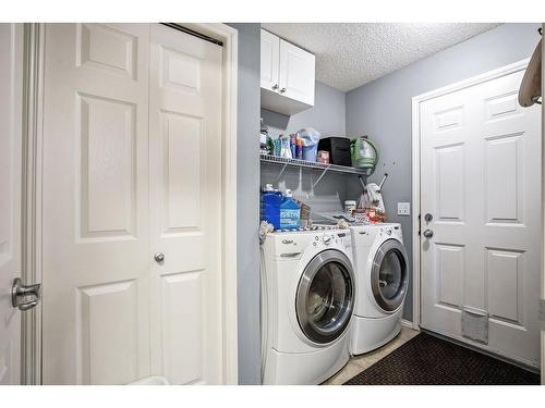 145 Crystal Shores Grove, Okotoks, AB - Indoor Photo Showing Laundry Room