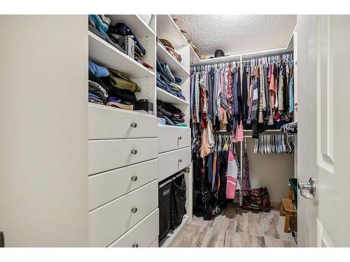 145 Crystal Shores Grove, Okotoks, AB - Indoor With Storage