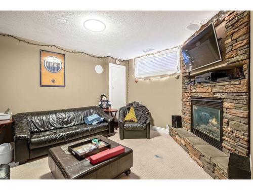 145 Crystal Shores Grove, Okotoks, AB - Indoor Photo Showing Living Room With Fireplace