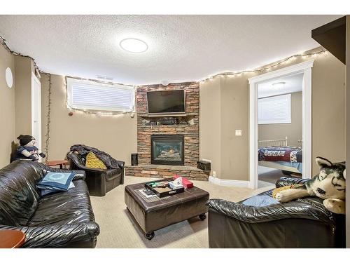 145 Crystal Shores Grove, Okotoks, AB - Indoor Photo Showing Living Room With Fireplace