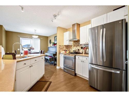 145 Crystal Shores Grove, Okotoks, AB - Indoor Photo Showing Kitchen With Stainless Steel Kitchen