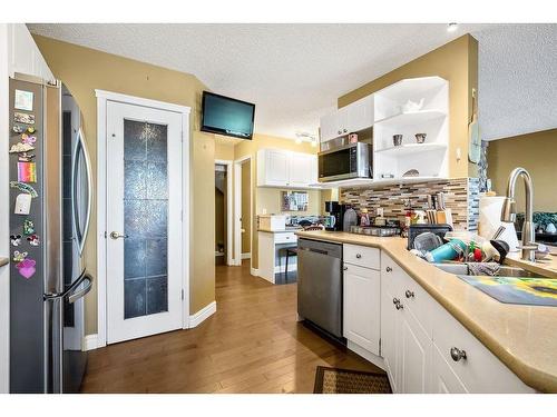 145 Crystal Shores Grove, Okotoks, AB - Indoor Photo Showing Kitchen With Stainless Steel Kitchen