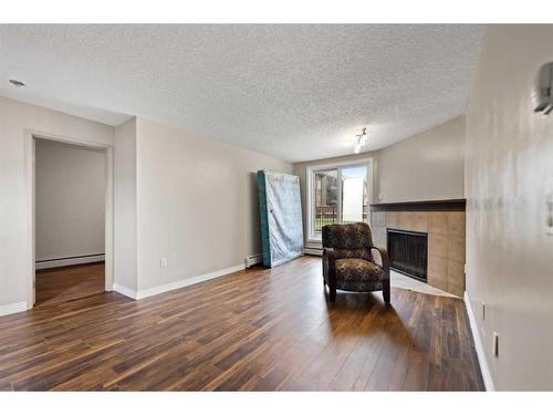 1108-13045 6 Street Sw, Calgary, AB - Indoor Photo Showing Living Room With Fireplace