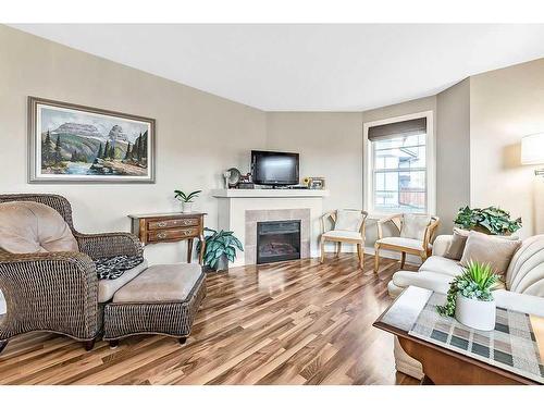 318-50 Westland Road, Okotoks, AB - Indoor Photo Showing Living Room With Fireplace