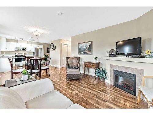 318-50 Westland Road, Okotoks, AB - Indoor Photo Showing Living Room With Fireplace