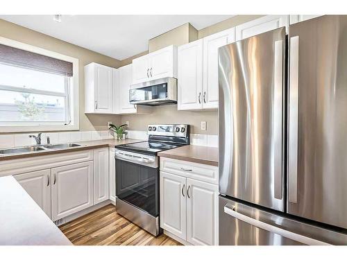 318-50 Westland Road, Okotoks, AB - Indoor Photo Showing Kitchen With Double Sink