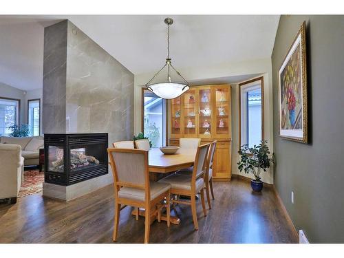 223 Hamptons Park Nw, Calgary, AB - Indoor Photo Showing Dining Room With Fireplace