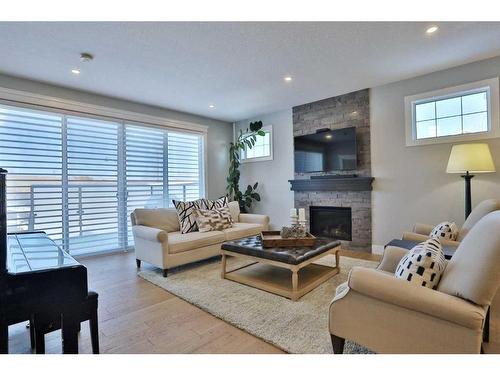 107 Crestridge Hill Sw, Calgary, AB - Indoor Photo Showing Living Room With Fireplace