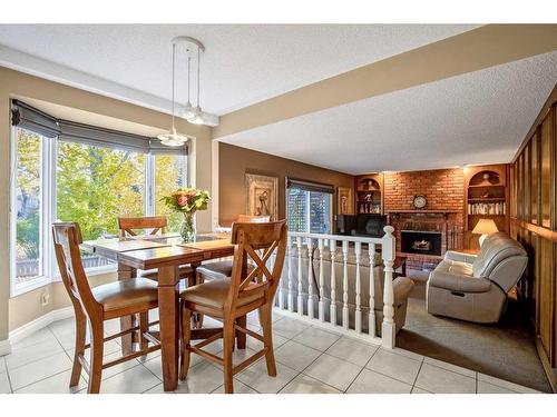 244 Cannington Place Sw, Calgary, AB - Indoor Photo Showing Dining Room With Fireplace