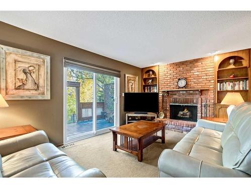 244 Cannington Place Sw, Calgary, AB - Indoor Photo Showing Living Room With Fireplace