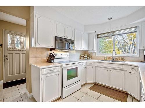 244 Cannington Place Sw, Calgary, AB - Indoor Photo Showing Kitchen With Double Sink