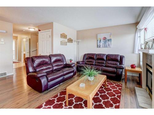 8-12 Silver Creek Boulevard Nw, Airdrie, AB - Indoor Photo Showing Living Room With Fireplace