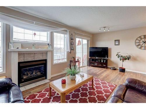 8-12 Silver Creek Boulevard Nw, Airdrie, AB - Indoor Photo Showing Living Room With Fireplace