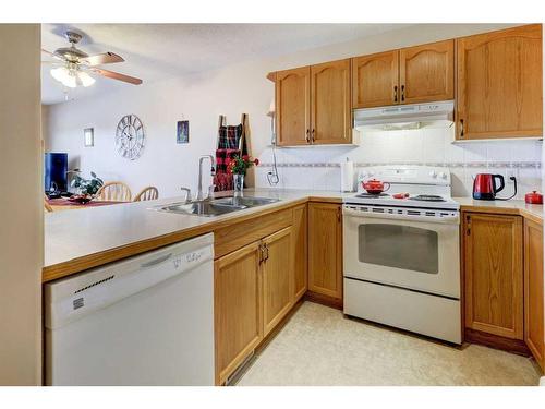 8-12 Silver Creek Boulevard Nw, Airdrie, AB - Indoor Photo Showing Kitchen With Double Sink