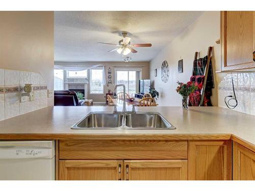 8-12 Silver Creek Boulevard Nw, Airdrie, AB - Indoor Photo Showing Kitchen With Double Sink