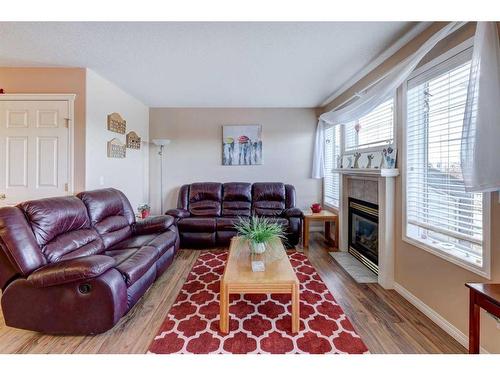 8-12 Silver Creek Boulevard Nw, Airdrie, AB - Indoor Photo Showing Living Room With Fireplace