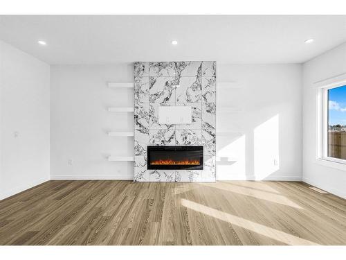 853 Midtown Drive Sw, Airdrie, AB - Indoor Photo Showing Living Room With Fireplace