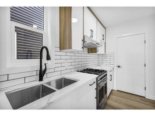 853 Midtown Drive Sw, Airdrie, AB - Indoor Photo Showing Kitchen With Double Sink