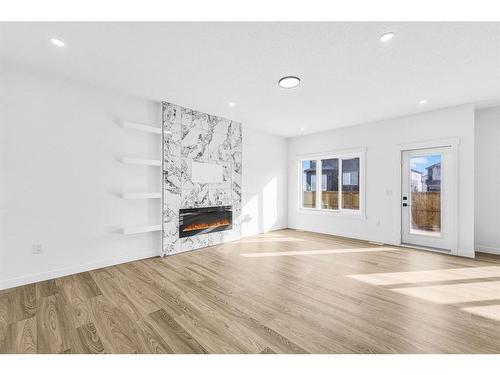 853 Midtown Drive Sw, Airdrie, AB - Indoor Photo Showing Living Room With Fireplace