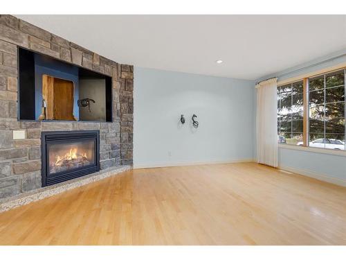 1239 Hunterquay Hill Nw, Calgary, AB - Indoor Photo Showing Living Room With Fireplace