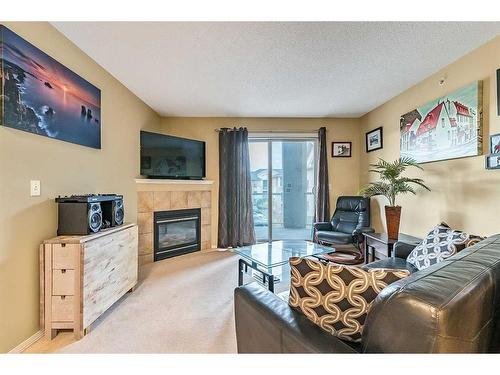 2313-2518 Fish Creek Boulevard Sw, Calgary, AB - Indoor Photo Showing Living Room With Fireplace