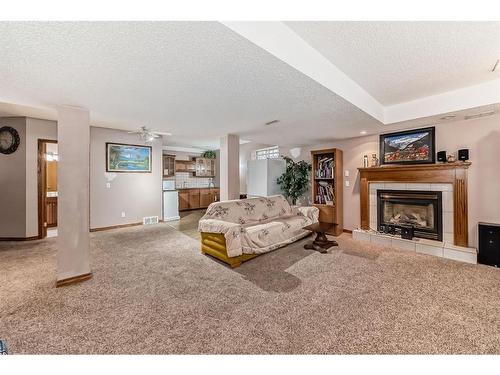 66 Woodpark Circle Sw, Calgary, AB - Indoor Photo Showing Living Room With Fireplace