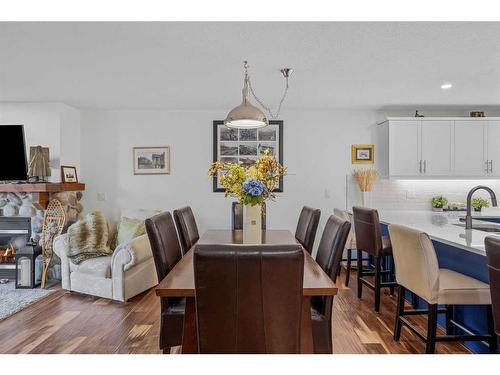 201-150 Crossbow Landing, Canmore, AB - Indoor Photo Showing Dining Room With Fireplace