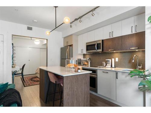 321-619 Confluence Way Se, Calgary, AB - Indoor Photo Showing Kitchen With Stainless Steel Kitchen With Upgraded Kitchen