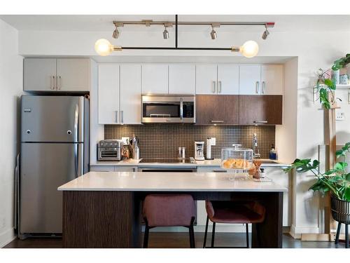 321-619 Confluence Way Se, Calgary, AB - Indoor Photo Showing Kitchen With Stainless Steel Kitchen With Upgraded Kitchen