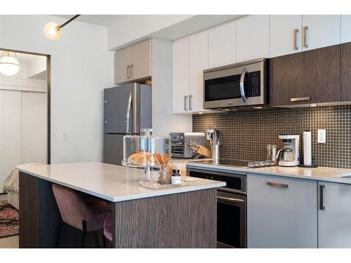 321-619 Confluence Way Se, Calgary, AB - Indoor Photo Showing Kitchen With Stainless Steel Kitchen With Upgraded Kitchen