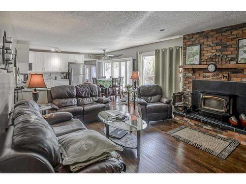 223015 Range Road 274, Rural Rocky View County, AB - Indoor Photo Showing Living Room With Fireplace