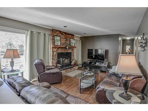 223015 Range Road 274, Rural Rocky View County, AB - Indoor Photo Showing Living Room With Fireplace