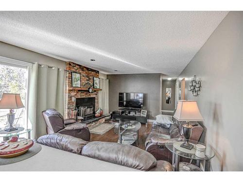 223015 Range Road 274, Rural Rocky View County, AB - Indoor Photo Showing Living Room With Fireplace