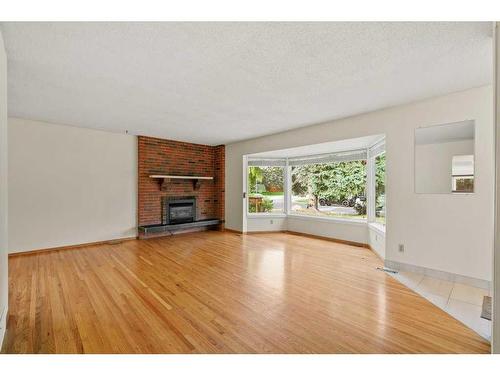 11408 Wilcox Street Se, Calgary, AB - Indoor Photo Showing Living Room With Fireplace