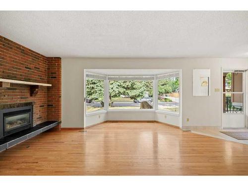 11408 Wilcox Street Se, Calgary, AB - Indoor Photo Showing Living Room With Fireplace